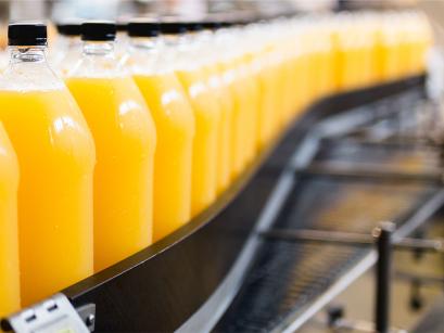 bottles of juice on a conveyer belt