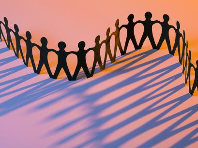 Cut out of paper people holding hands