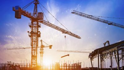 Construction cranes at sunrise