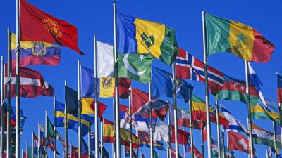 Flags of various countries against blue sky
