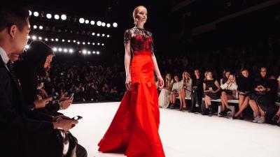 Model in red dress on runway