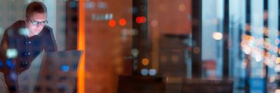 Man in building looking at a computer