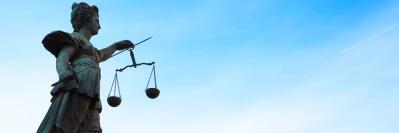 Statue of Lady Justice against blue sky