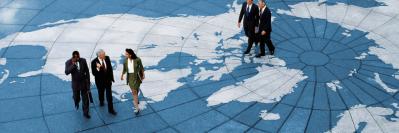 Business people walking on map of world 